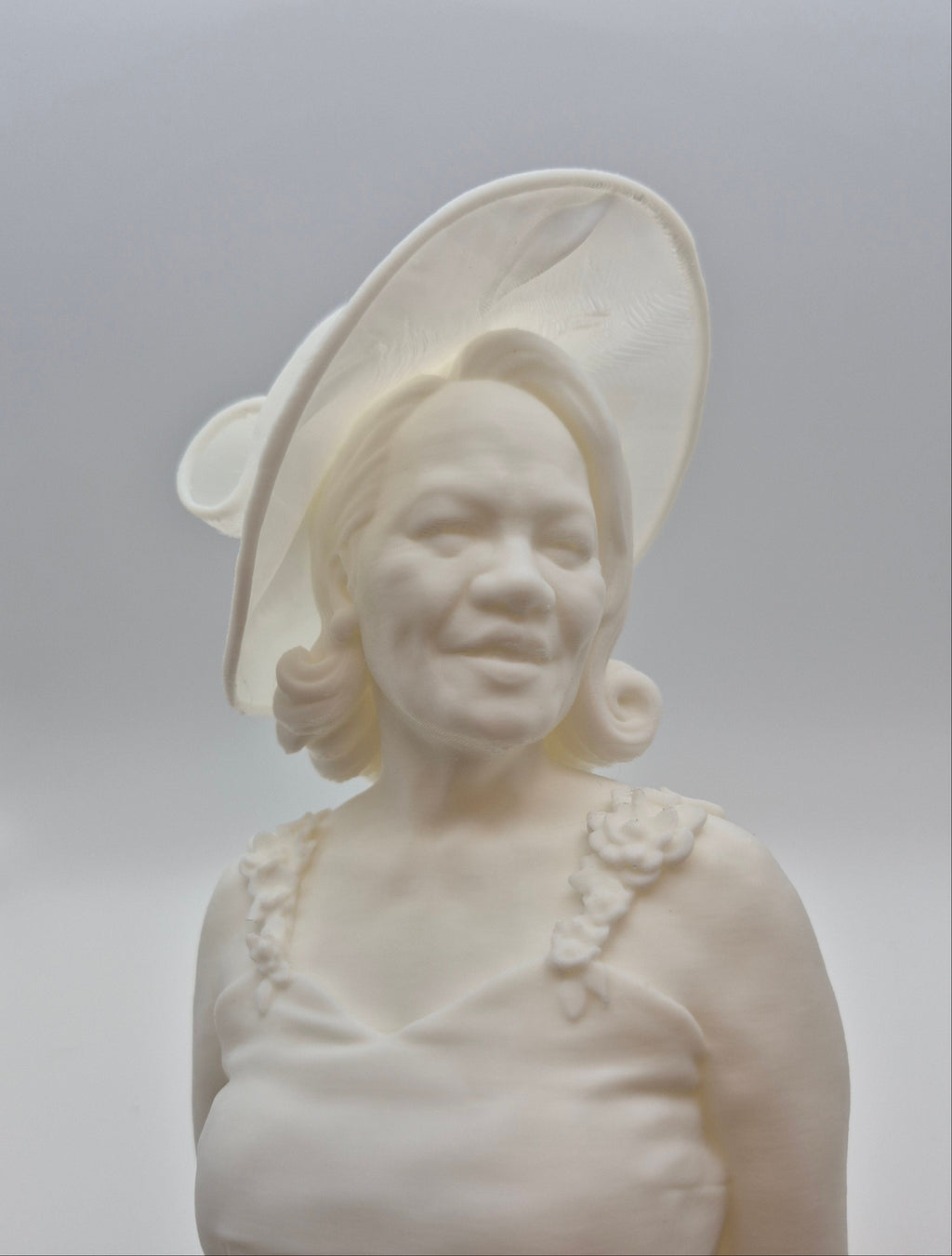 White marble bust of a woman on a gray background